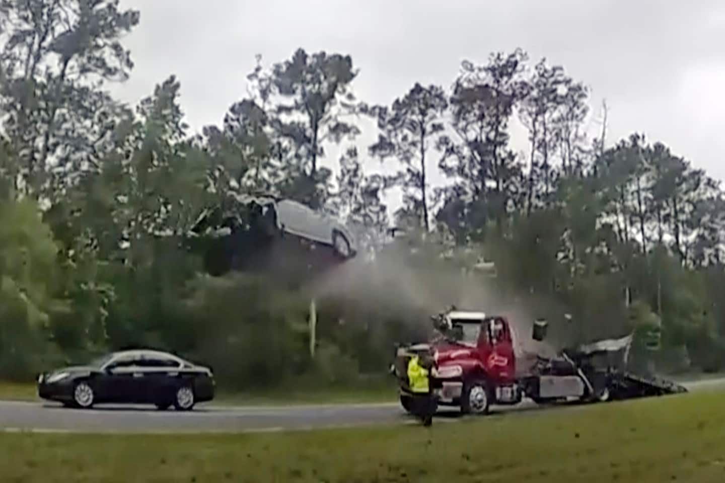 Woman drives onto tow truck ramp and flies 120 feet in crash, video shows