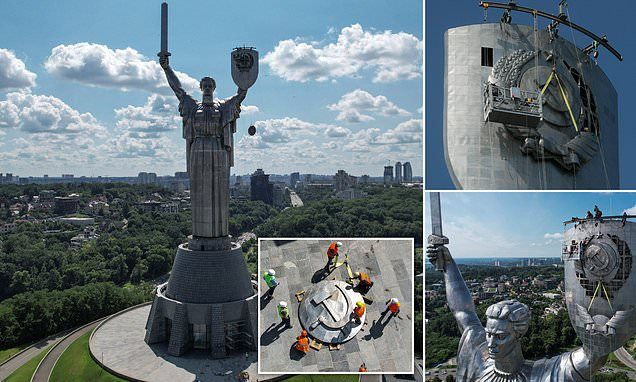 Ukraine pulls down Soviet hammer and sickle from towering 335ft 'Motherland' statue in heart of Kyiv commemorating WWII in latest symbol of defiance to Vladimir Putin