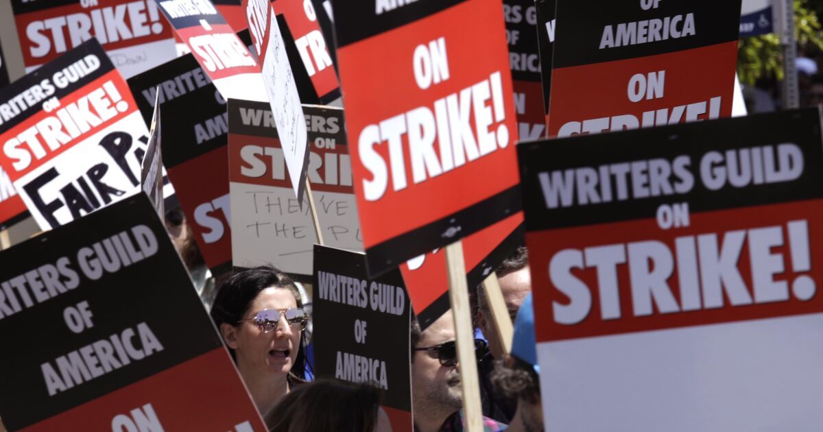 Striking Hollywood writers picket studios for better pay. 'It's not sustainable'