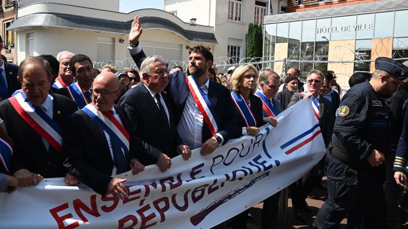 France protests: Hundreds march with mayor whose house was attacked by burning car