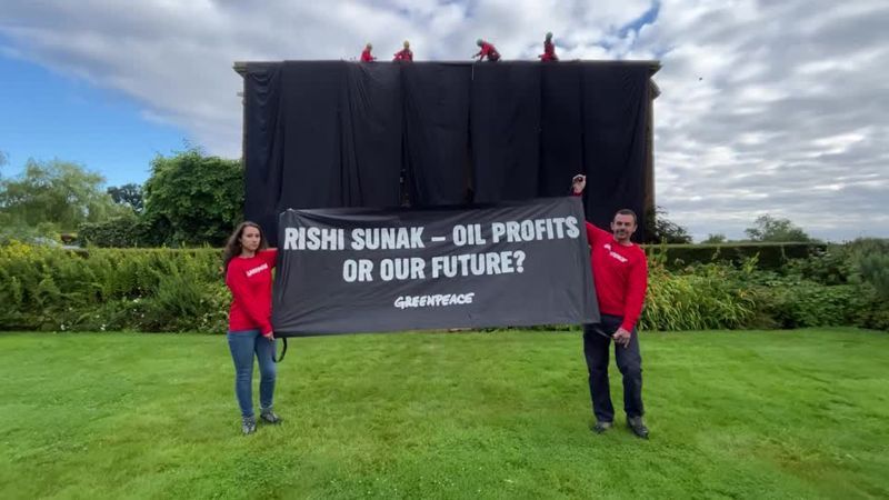 Activists cover Rishi Sunak's mansion in black cloth after climbing onto the roof with ropes and ladders