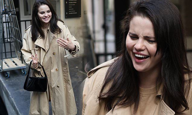 Selena Gomez exudes Parisian chic in a stylish trench coat as she cheerfully greets fans in France