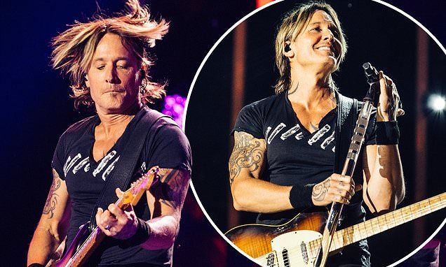 Keith Urban performs at CMA Fest in Nashville, showing off his tattoos and biceps in tight T-shirt