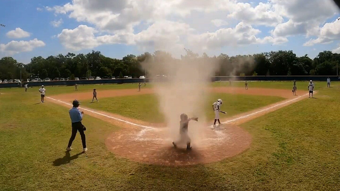 Watch: Florida umpire snatches 7-year-old catcher from dust devil