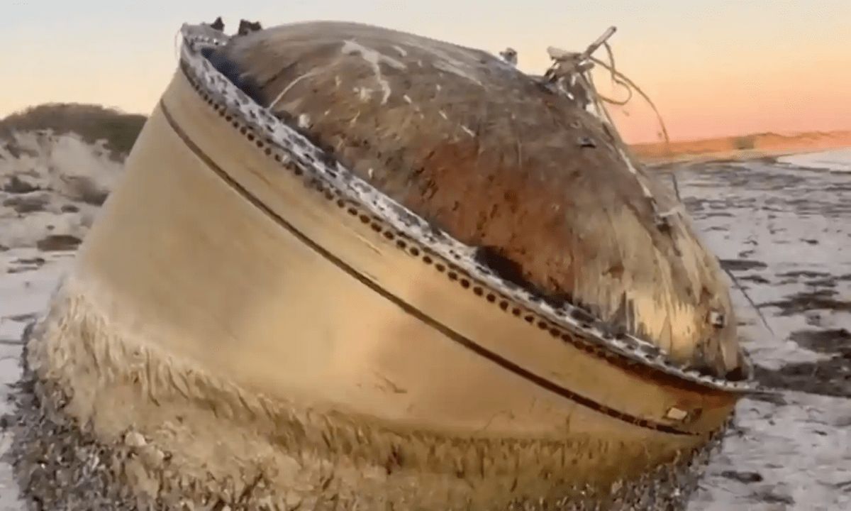 Australian authorities warn locals to stay away from the mysterious metal cylinder on the beach