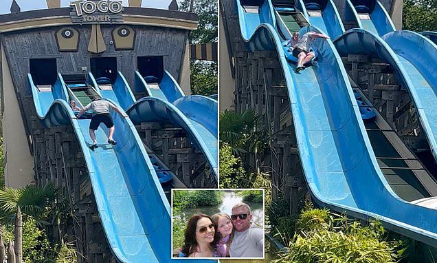 Moment father climbs up waterslide to rescue his terrified daughter