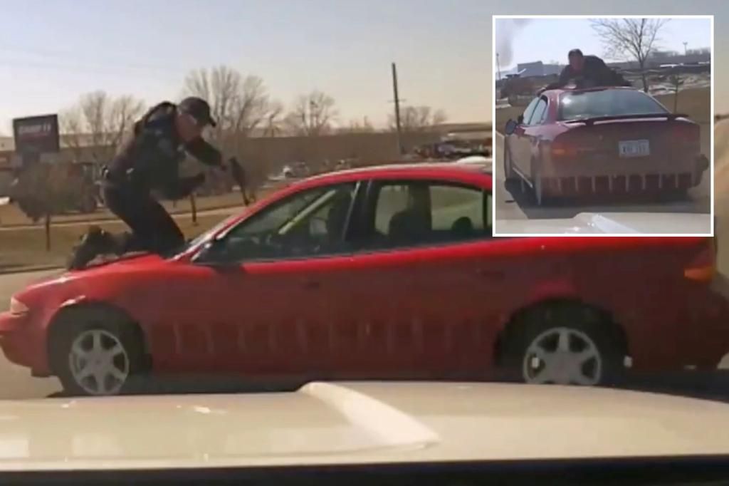 Iowa cop clings to hood of car, breaks his back in wild chase caught on video