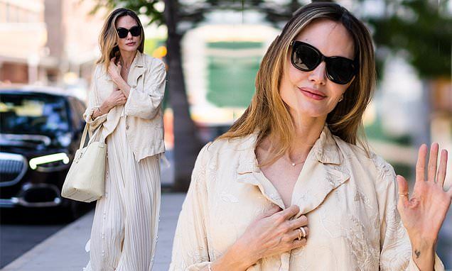 Angelina Jolie cuts a chic figure in pleated cream maxi dress and coordinating jacket during outing