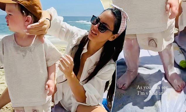 Olivia Munn jokes that 'it takes two adults to put sunscreen on one toddler' during beach day with partner John Mulaney and son Malcolm