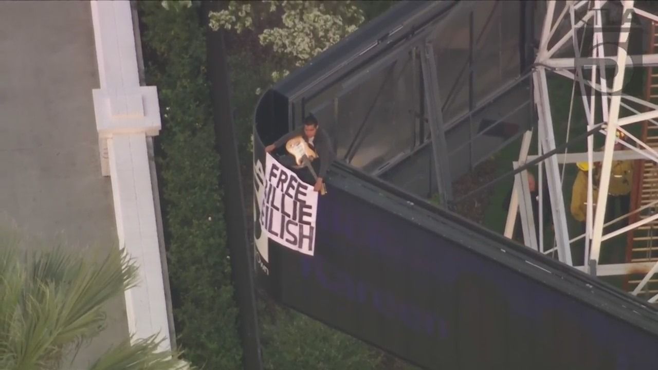 Man climbs KTLA radio tower holding ‘Free Billie Eilish’ sign