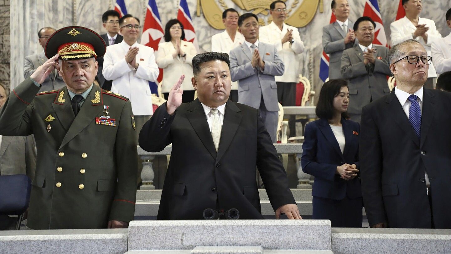 Russian and Chinese delegates join North Korean leader Kim at a parade showing his newest missiles