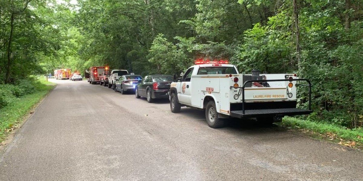 Officials: 1 dead, 1 missing after cabin swept into creek