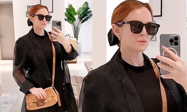 Lindsay Lohan shows off her growing baby bump while rocking a black minidress in new mirror selfie