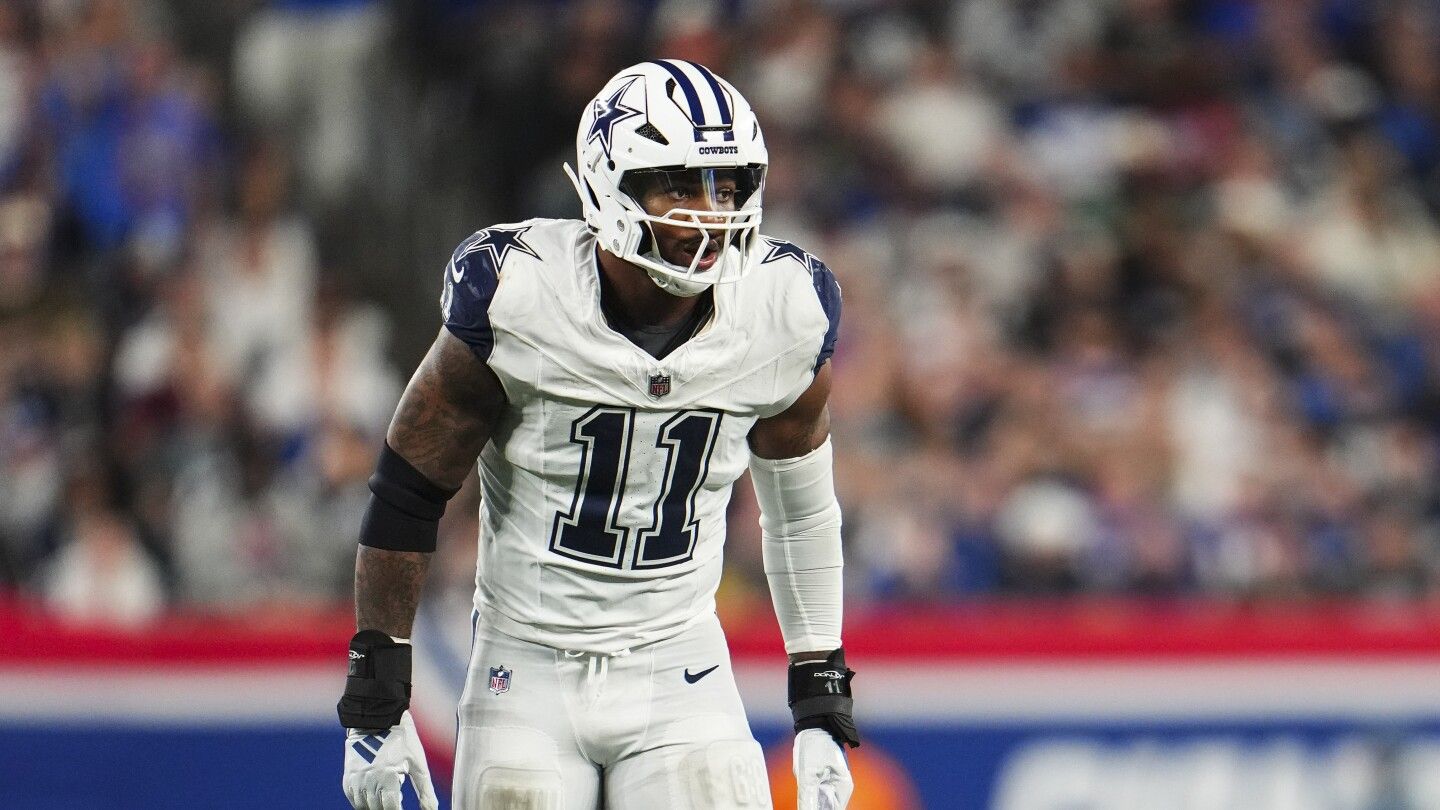 Micah Parsons wearing a boot and using a scooter