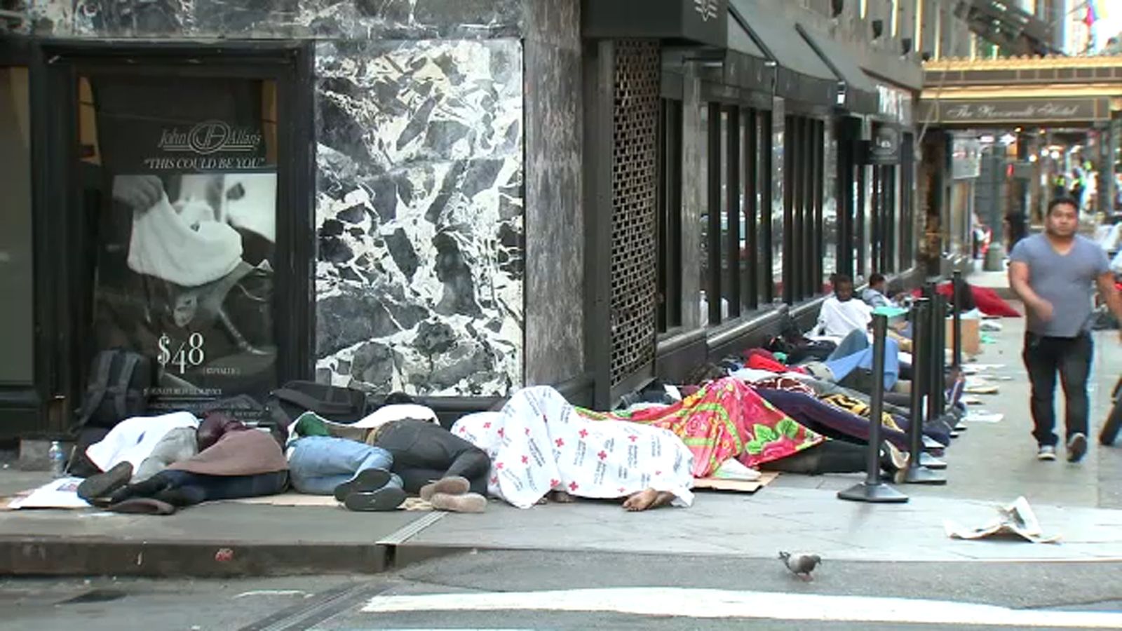 Migrants sleeping outside, stretching around Roosevelt Hotel's Midtown block