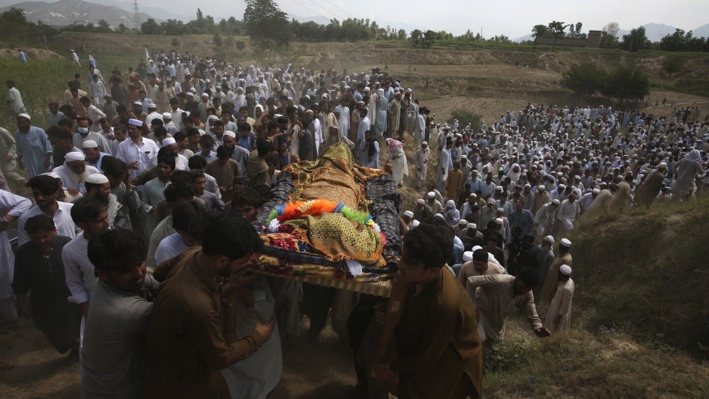 Pakistan buries dead from massive suicide bombing at political rally